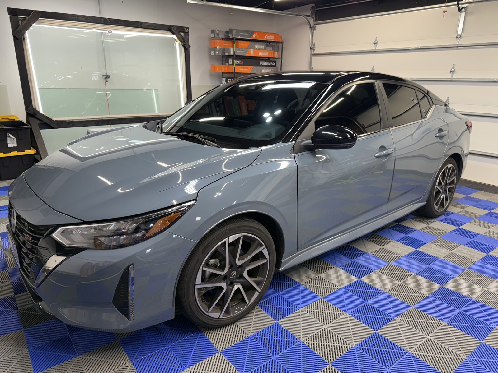 Blue Nissan with tinted windows